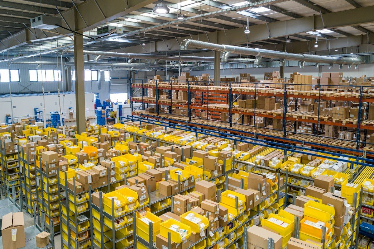 Racked shelving in a high-volume distribution warehouse with cartons staged for outbound shipment.